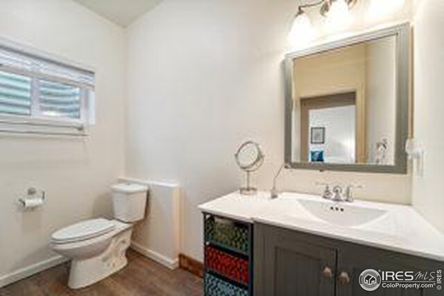 bathroom featuring hardwood / wood-style floors, vanity, and toilet