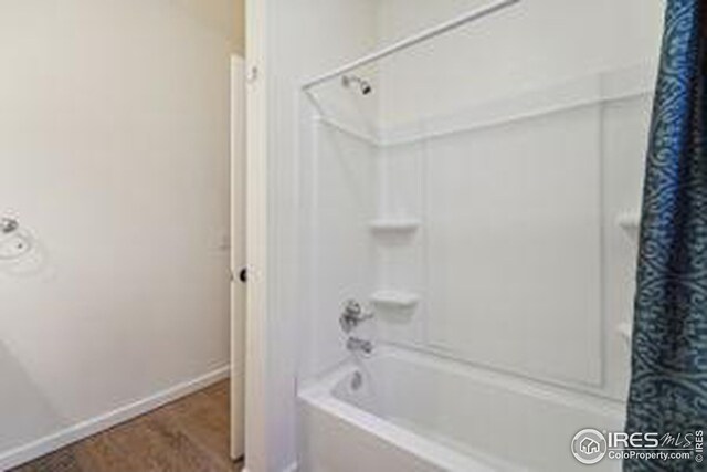 bathroom with shower / bath combination with curtain and hardwood / wood-style flooring