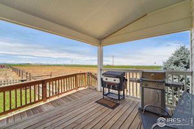 wooden terrace featuring a rural view