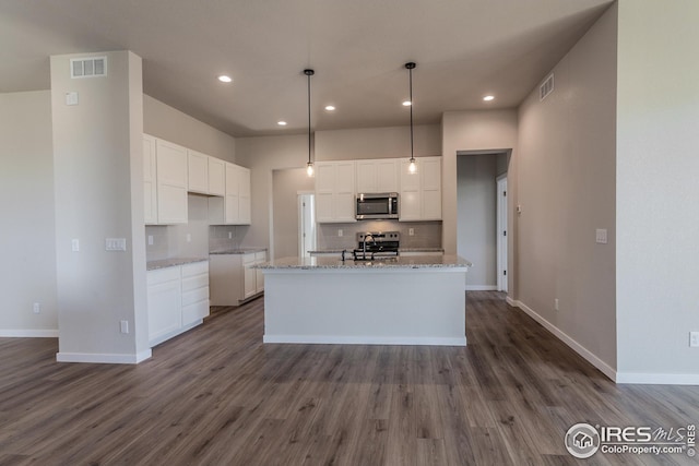 1215 105th Avenue Ct, Greeley, CO 80634 - kitchen with backsplash, stainless steel appliances, visible vents, white cabinets, and dark wood-type flooring