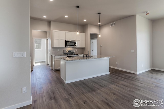 1215 105th Avenue Ct, Greeley, CO 80634 - kitchen with visible vents, stainless steel appliances, tasteful backsplash, white cabinetry, and dark wood-style floors