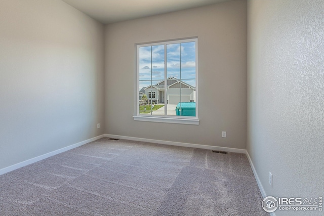 1215 105th Avenue Ct, Greeley, CO 80634 - carpeted spare room featuring baseboards and visible vents