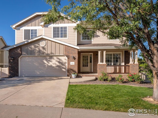 craftsman-style home featuring a porch, brick siding, board and batten siding, and a garage