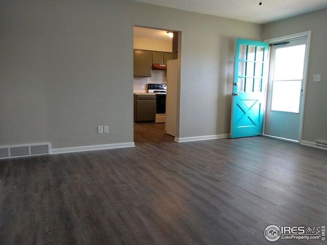 unfurnished living room featuring dark hardwood / wood-style flooring