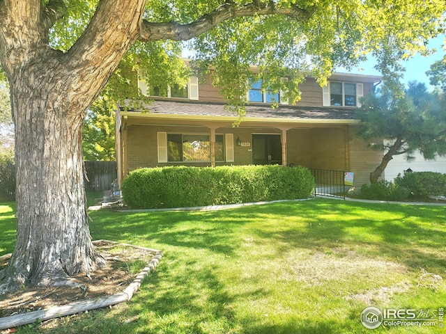 view of front of home featuring a front yard and a porch