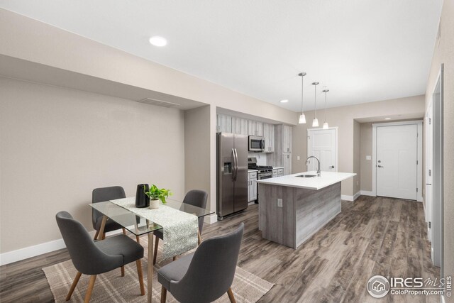 dining room with wood-type flooring and sink