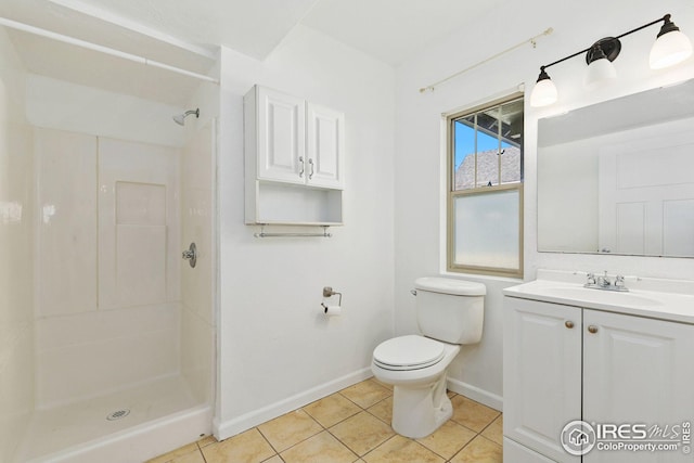 bathroom with a shower, vanity, tile patterned floors, and toilet