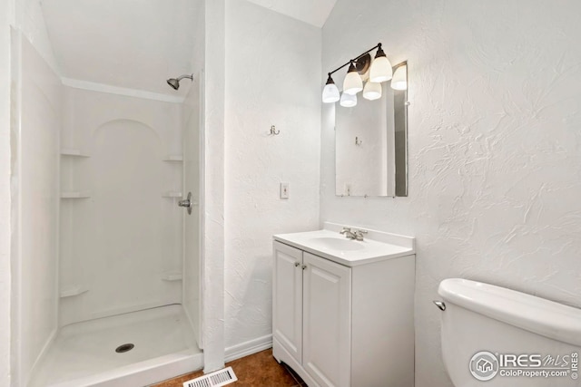 bathroom featuring a shower, vanity, and toilet