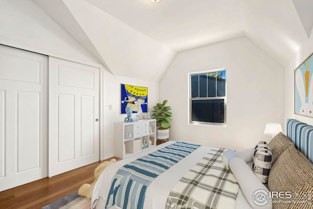 bedroom with lofted ceiling and hardwood / wood-style floors