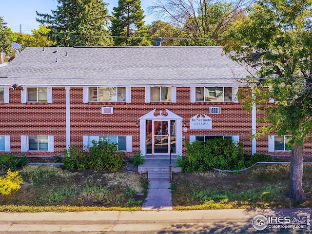 1391 Lima St, Aurora, CO 80010 - view of front facade with a shingled roof and brick siding