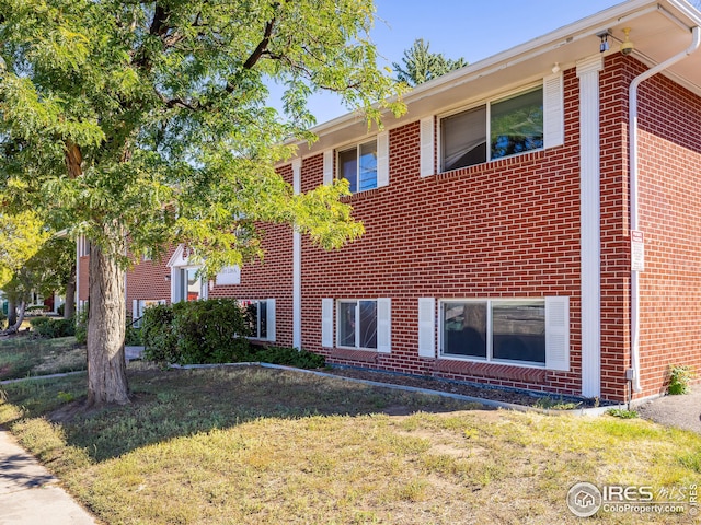 1391 Lima St, Aurora, CO 80010 - view of side of home with brick siding and a lawn