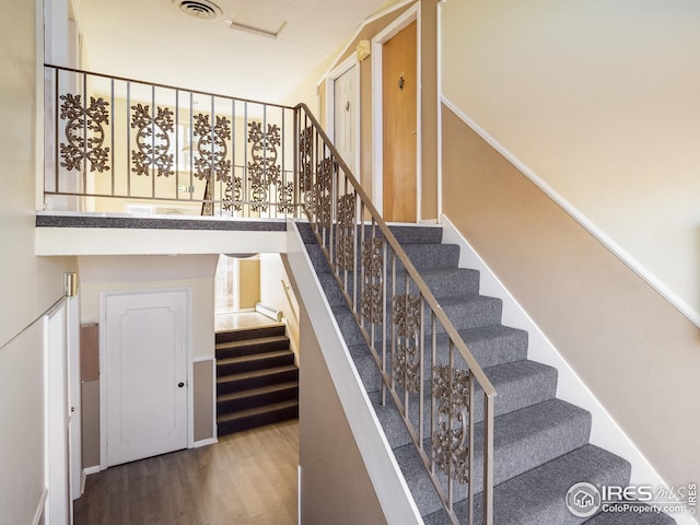 1391 Lima St, Aurora, CO 80010 - staircase featuring wood finished floors