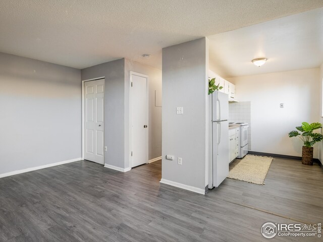 1391 Lima St, Aurora, CO 80010 - kitchen with white appliances, white cabinets, dark wood-style flooring, and a textured ceiling