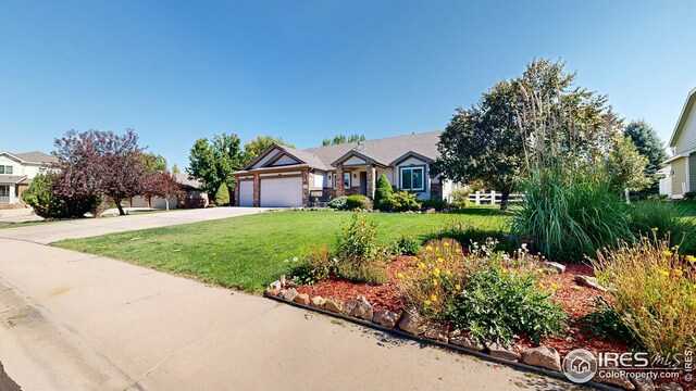 view of front of home with a front lawn and a garage