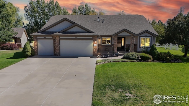 view of front of home featuring a porch, a garage, and a lawn