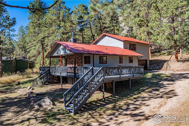 view of front of property with metal roof and stairs