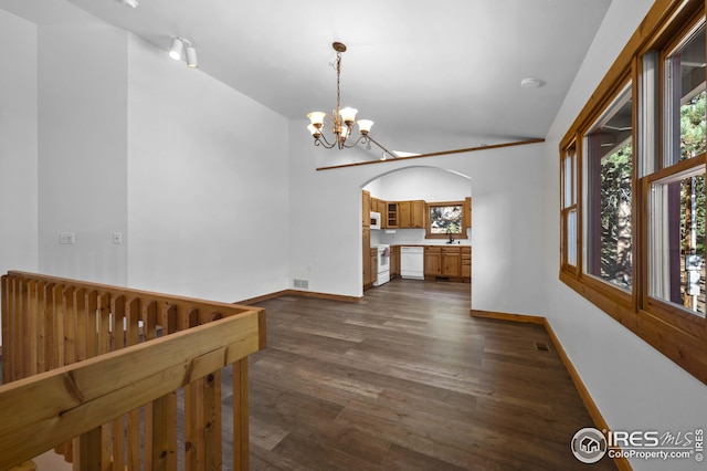 unfurnished dining area with baseboards, dark wood-type flooring, and a notable chandelier