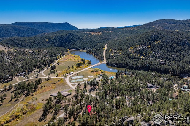 bird's eye view featuring a water and mountain view and a forest view