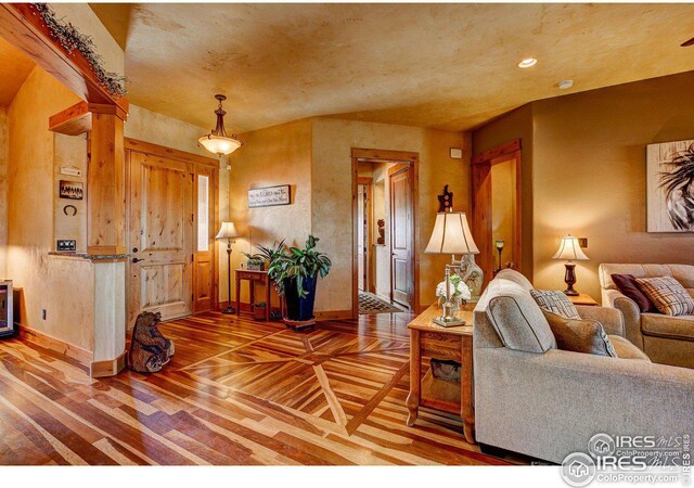 living area featuring recessed lighting, baseboards, and wood finished floors