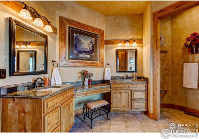 full bath featuring double vanity, a sink, visible vents, and tile patterned floors