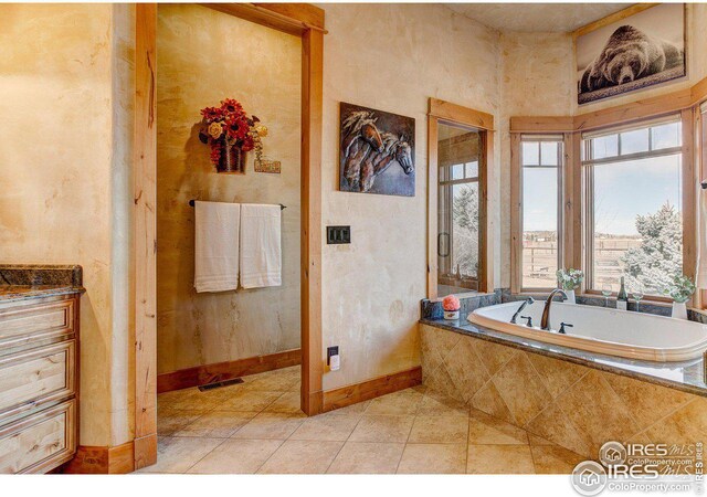 full bathroom featuring a bath, baseboards, visible vents, and tile patterned floors