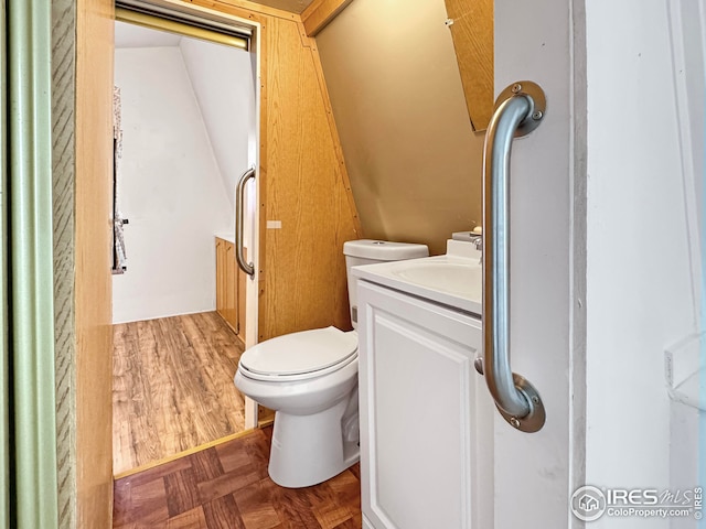 half bathroom with toilet and vanity