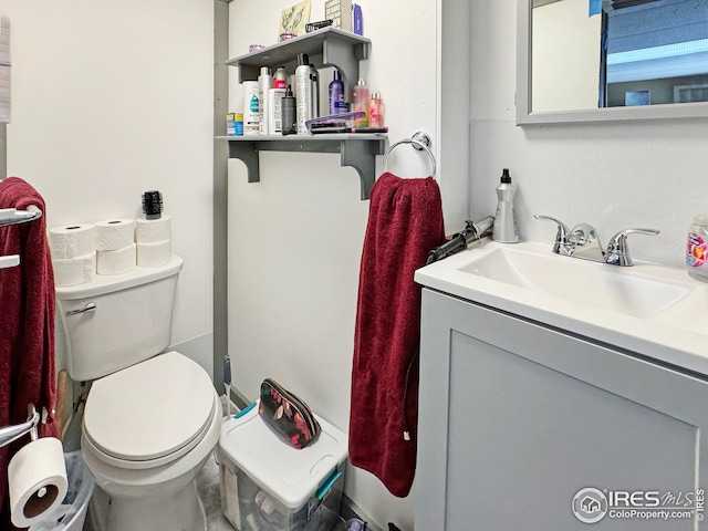 bathroom featuring toilet and vanity