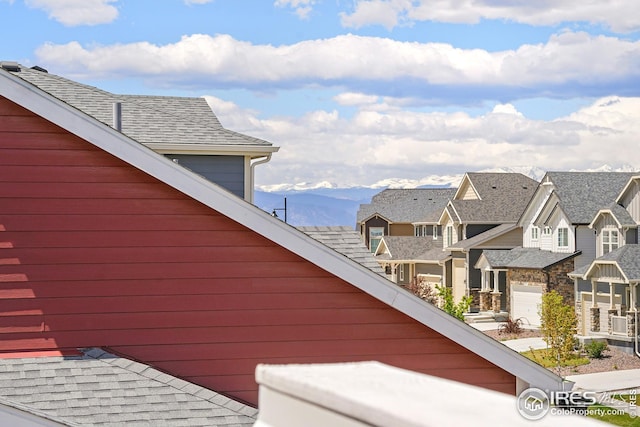 view of home's exterior with cooling unit, a mountain view, and a garage