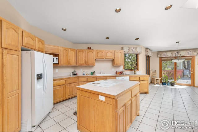 kitchen with pendant lighting, a center island, light brown cabinets, white appliances, and light tile patterned floors