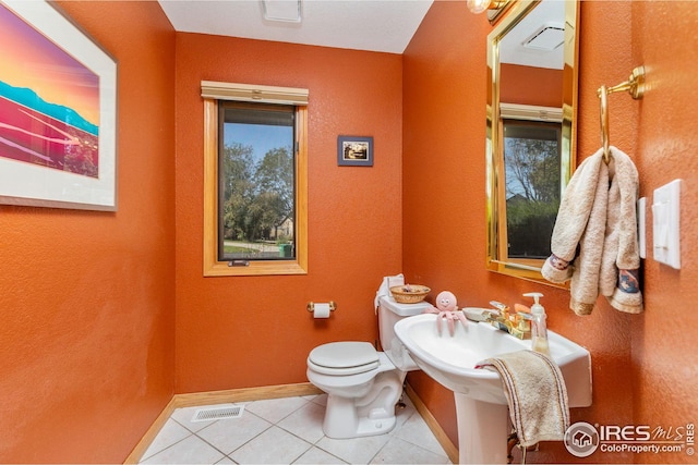 bathroom featuring toilet and tile patterned floors