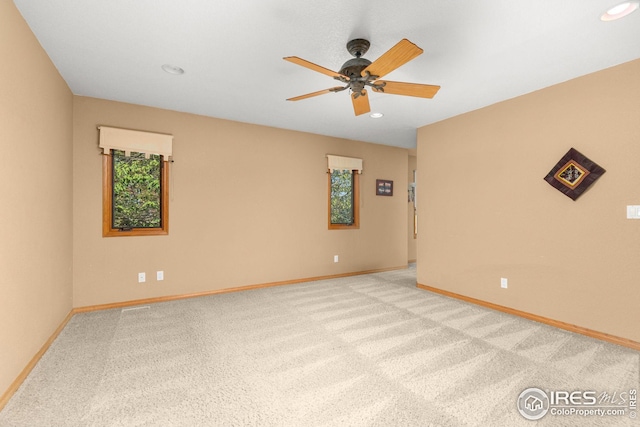 carpeted empty room featuring ceiling fan