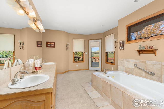 bathroom with vanity and tiled tub