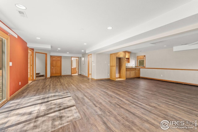 unfurnished living room with dark wood-type flooring