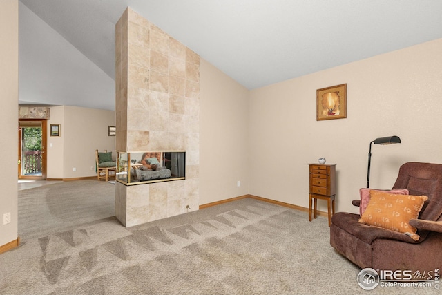 living area with carpet flooring, a fireplace, and high vaulted ceiling