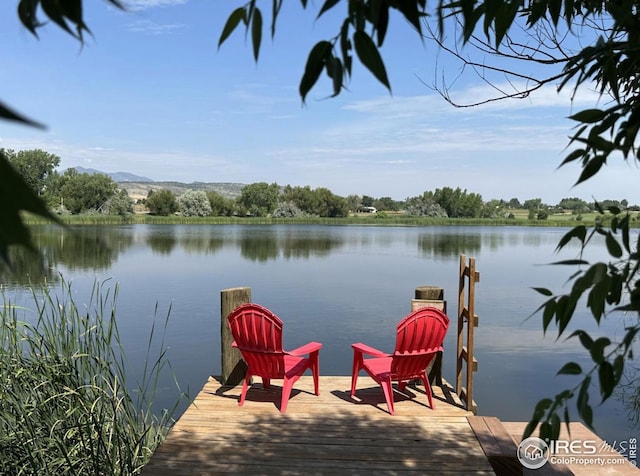 view of dock featuring a water and mountain view