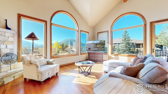 sunroom / solarium featuring vaulted ceiling