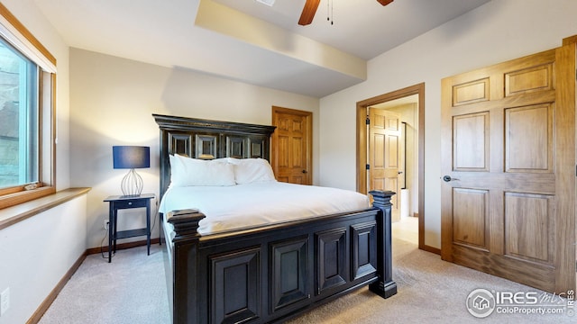 carpeted bedroom with multiple windows and ceiling fan