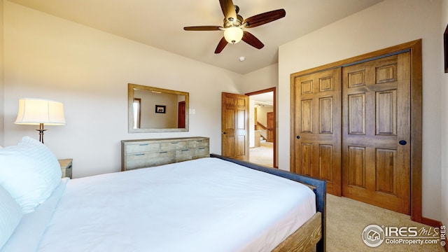 bedroom featuring ceiling fan, light carpet, and a closet