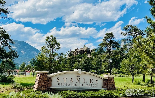 community sign with a mountain view