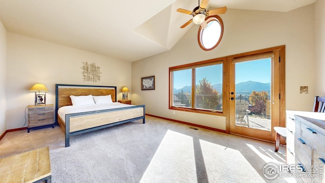 carpeted bedroom featuring ceiling fan, a mountain view, multiple windows, and access to outside