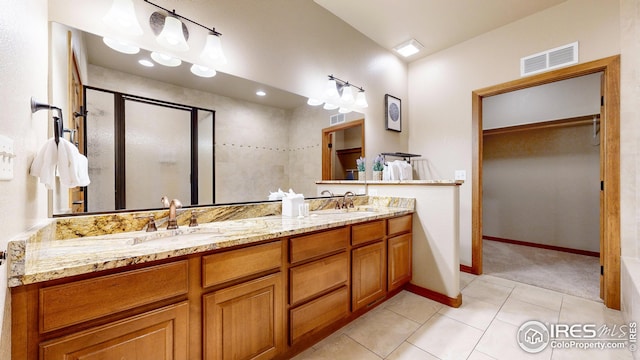 bathroom with vanity, tile patterned floors, and an enclosed shower