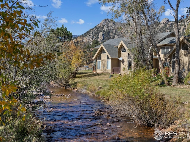 view of side of home featuring a water and mountain view