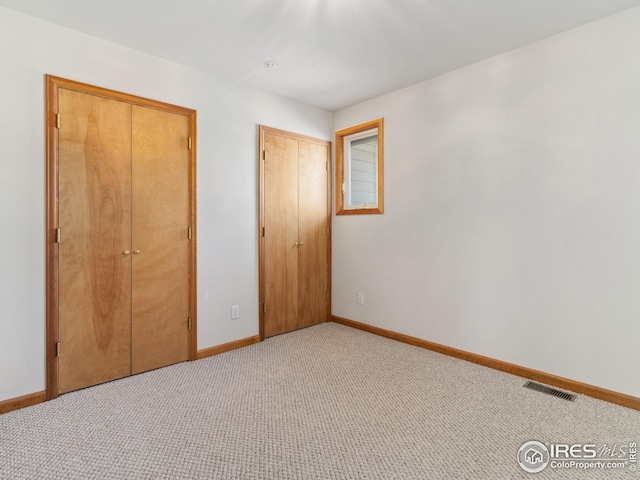 unfurnished bedroom featuring light carpet