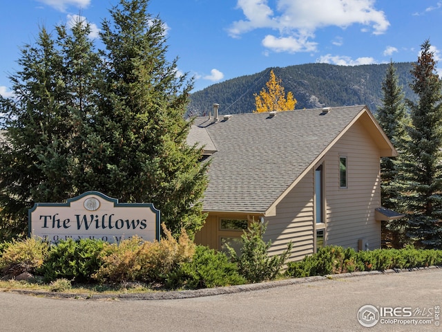 community / neighborhood sign with a mountain view