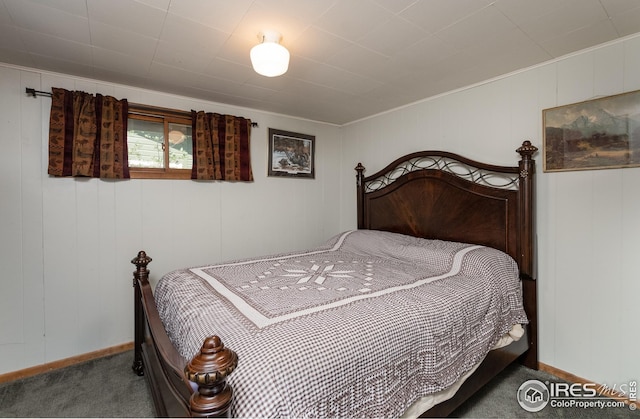 bedroom featuring carpet floors and baseboards