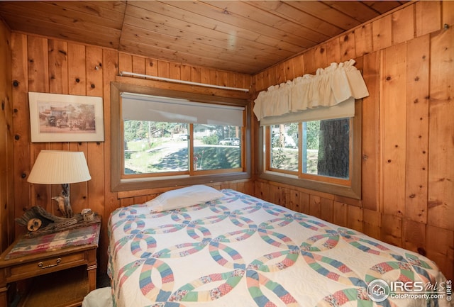 bedroom featuring wood ceiling and wooden walls