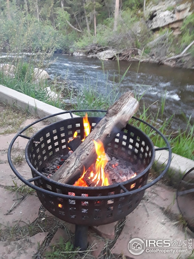 exterior details featuring an outdoor fire pit