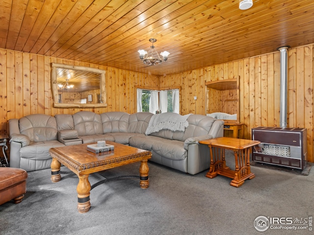 living area featuring carpet floors, an inviting chandelier, wood ceiling, and a wood stove