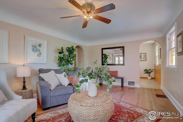 living room with light colored carpet and wood walls