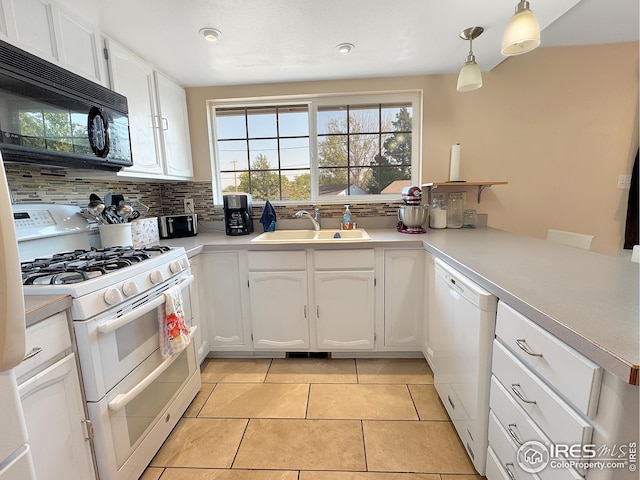 kitchen with tasteful backsplash, white cabinets, white appliances, sink, and hanging light fixtures